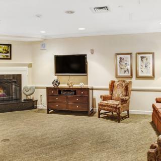 A cozy living room with a fireplace, television, and comfortable seating.
