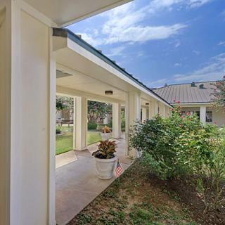 A charming house with a covered porch and garden.