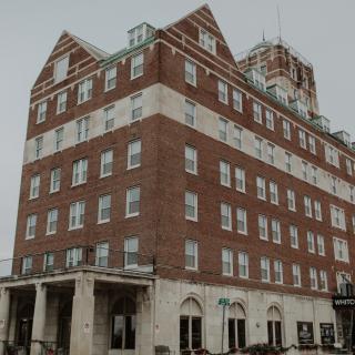A historic brick hotel building in an urban setting.