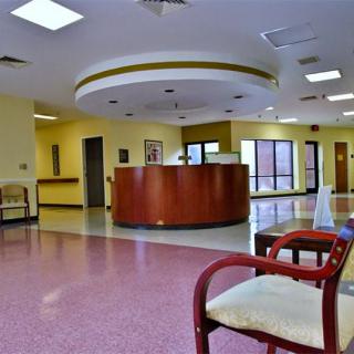 A spacious lobby with a central reception desk and seating area.