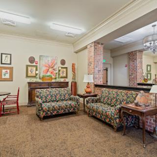A cozy living room featuring patterned sofas and decorative artwork.
