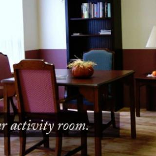 A cozy activity room with a table and chairs, perfect for gatherings.