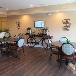 A cozy cafe interior with tables, chairs, and unique bicycle-themed decor.