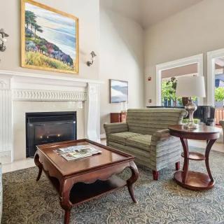 A cozy living room with a fireplace and elegant furniture.