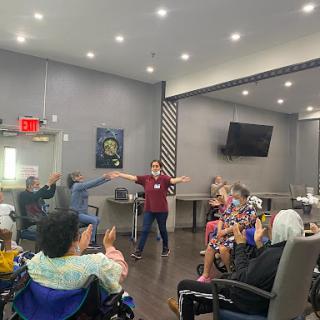 A lively group activity session for senior citizens, promoting engagement and social interaction.