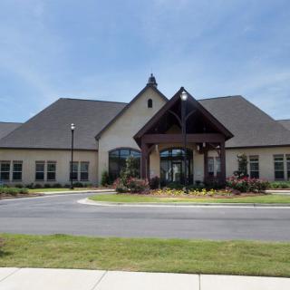 A suburban residential building with a prominent entrance and well-maintained landscaping.