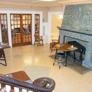 A cozy lobby area featuring a stone fireplace and inviting seating arrangements.