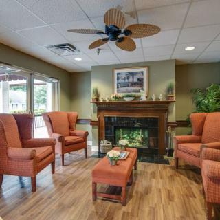 A cozy living room with comfortable seating arranged around a fireplace.