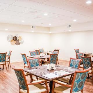 An elegant dining area with neatly arranged tables and chairs.