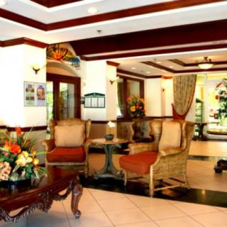 A luxurious hotel lobby with elegant furniture and floral decorations.