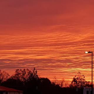 A stunning sunset paints the sky in vibrant shades of orange and pink, creating a serene atmosphere.