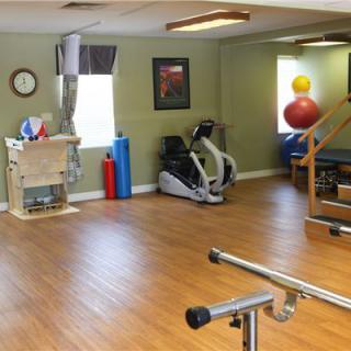 A physical therapy room with exercise equipment and gym facilities.