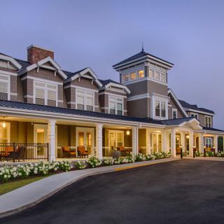A beautifully lit hotel building at dusk, showcasing its elegant architecture.