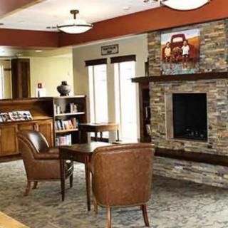 A cozy living room with a stone fireplace and comfortable seating arrangement.