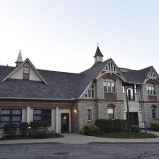 A charming residential building featuring intricate architectural design and elegant roofing.