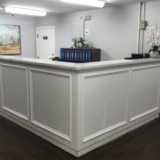 A modern reception desk in a well-lit office interior.