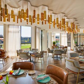 A modern and elegant restaurant interior with stylish lighting and a well-arranged dining area.