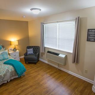 A cozy and modern bedroom with stylish furnishings and natural light.