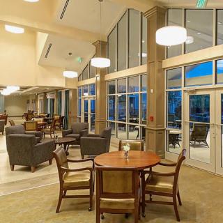 A modern lounge area with comfortable seating and large windows.