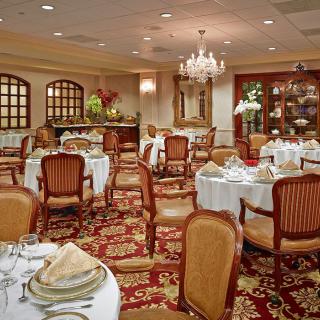 An elegant restaurant dining room with beautifully set tables and classic decor.
