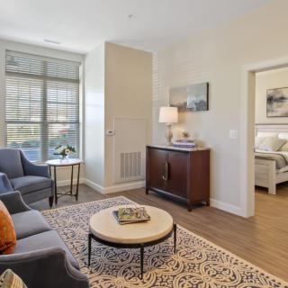 A cozy living room with modern furnishings and ample natural light.