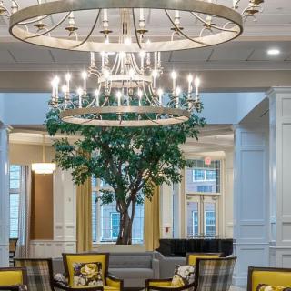 Elegant lobby with chandeliers and cozy seating area.