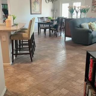 A cozy open-concept living and dining area featuring stylish furniture and elegant flooring.