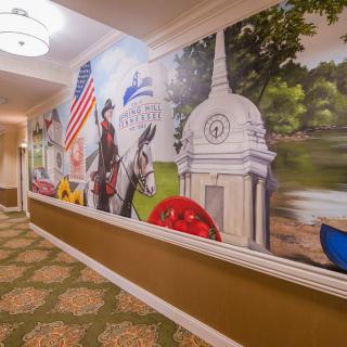 A hallway featuring a vibrant mural with cultural and historical symbols.
