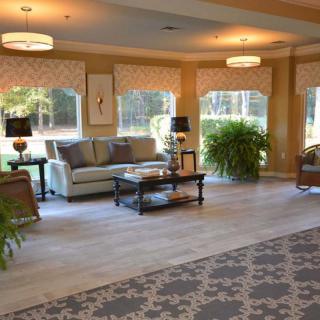 A spacious and elegantly decorated living room with large windows and comfortable seating.