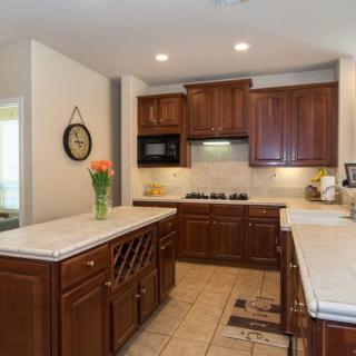 Modern kitchen with wooden cabinets and a spacious countertop.