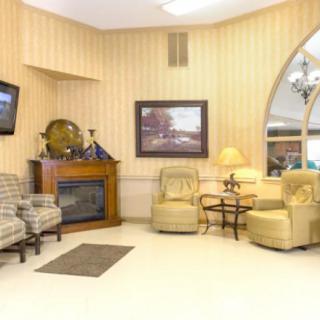 A cozy living room with comfortable seating, a fireplace, and a television.