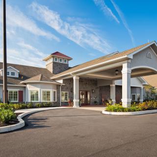 A modern building with a welcoming entrance under a clear blue sky.