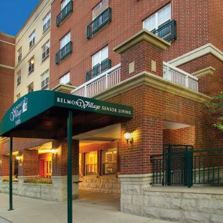 The image shows the exterior of a brick hotel building with an entrance canopy.