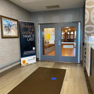 A welcoming entrance lobby featuring modern decor and informative signage.