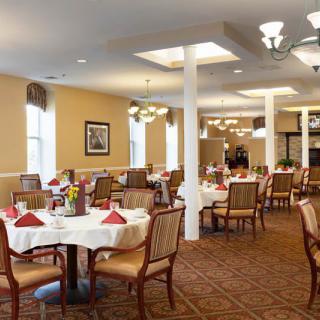 An elegantly decorated dining room with neatly arranged tables and comfortable seating.