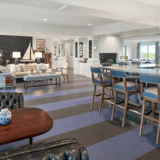 Modern open-concept living room featuring striped flooring and elegant bar seating.
