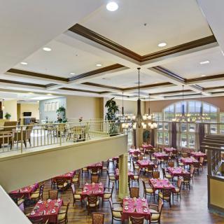 Spacious restaurant dining area with elegant decor and large windows.