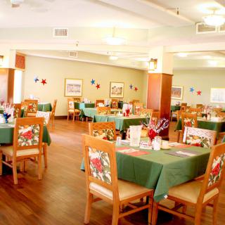 A brightly lit restaurant dining area with neatly arranged tables and chairs.