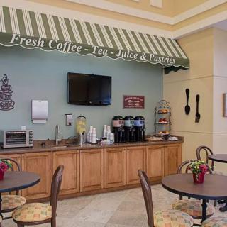 A cozy cafe with a coffee station, seating area, and inviting decor.