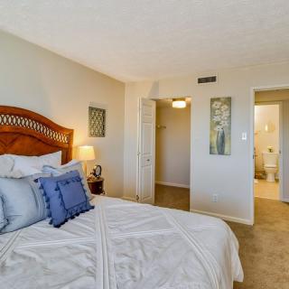 A cozy bedroom with a neatly made bed, soft lighting, and tasteful decor.