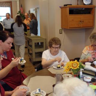 A group of people enjoying a social gathering with food indoors.