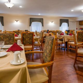 A neatly arranged dining room with elegant tables and chairs.