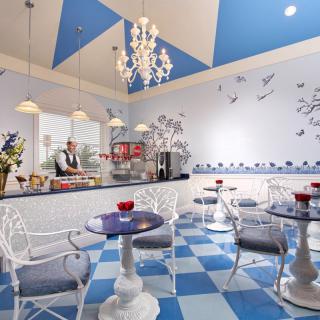 A charming caf� with blue and white decor, featuring a checkered floor and elegant chandelier.