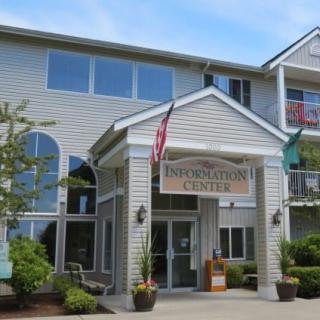 Entrance to a residential building with flags displayed.