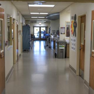 A view of a clean and well-lit hallway in a medical facility.