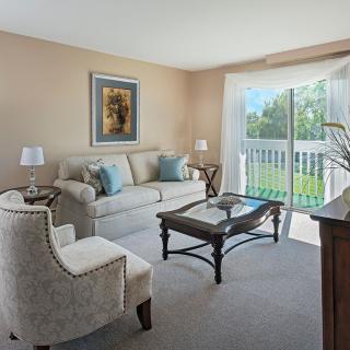 A cozy living room with comfortable seating and ample natural light.
