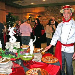 A lively event featuring a variety of delicious dishes, with a chef proudly presenting the food.