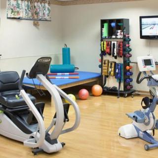 A well-equipped gym with various exercise machines and fitness tools.