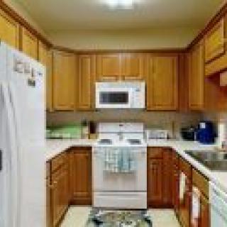 A cozy kitchen with wooden cabinets and modern appliances.
