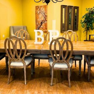 A cozy dining room featuring a wooden table and chairs, complemented by warm yellow walls and decorative elements.